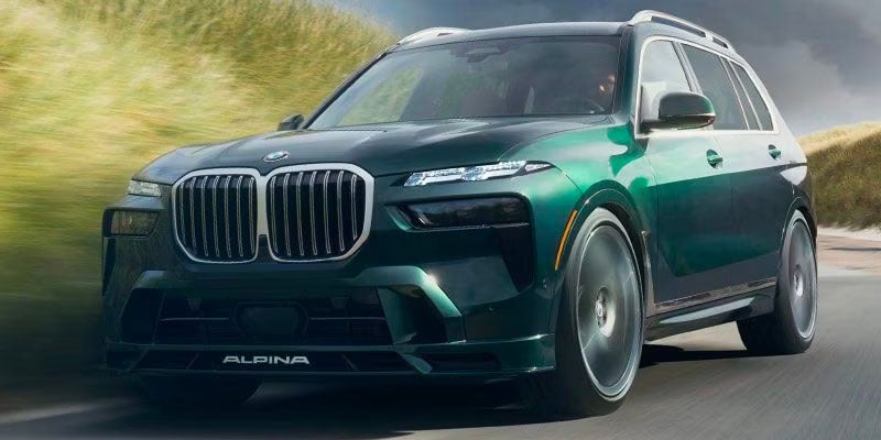 Front shot of 2024 BMW X7 driving down road in desert